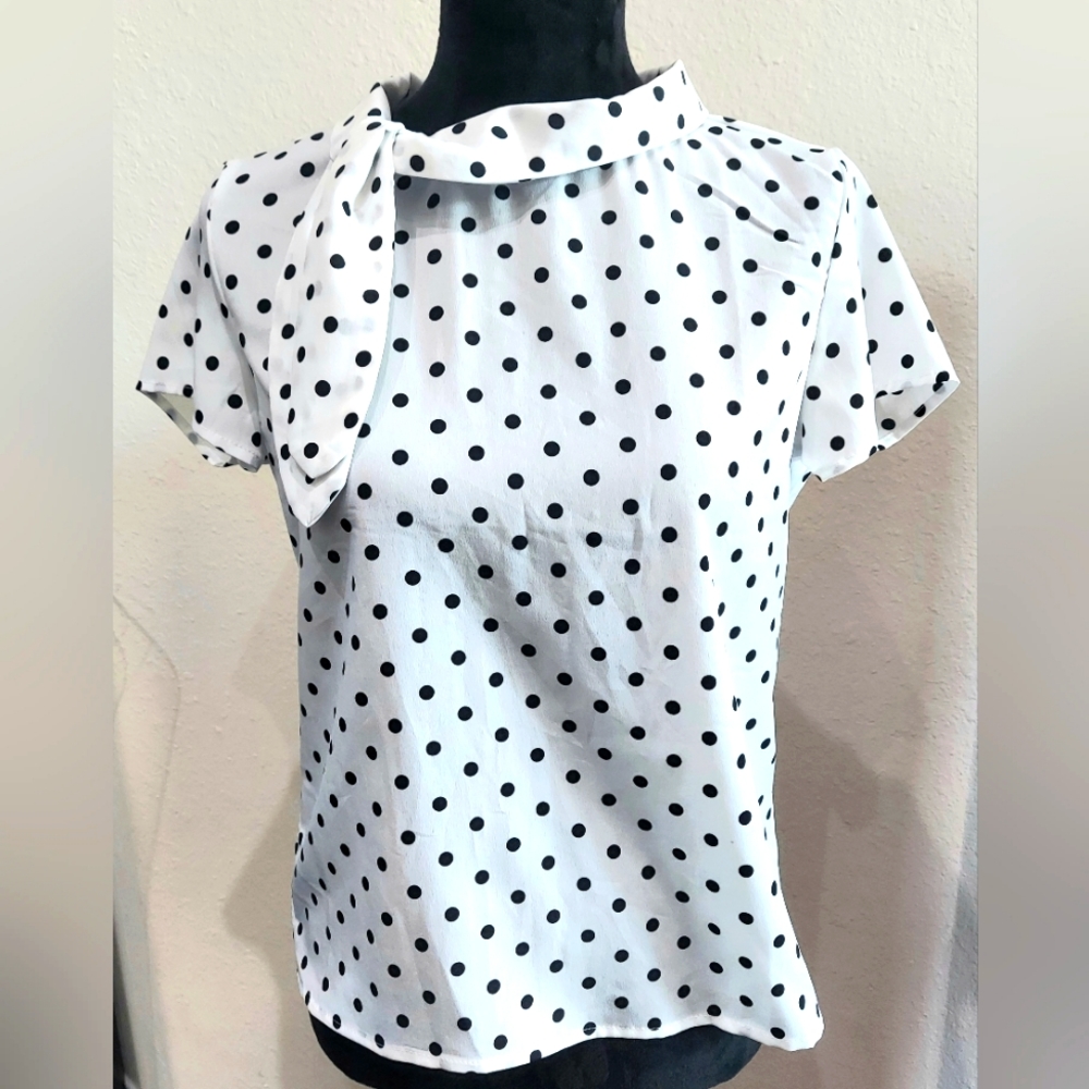White short sleeve blouse with black polka dots and bow at the neck